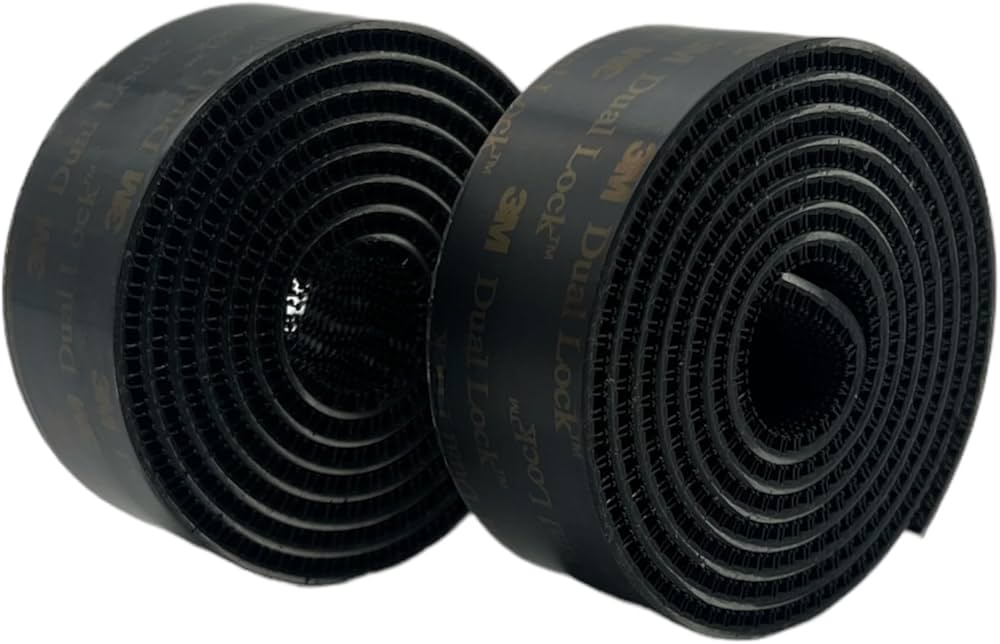 Two black rolls of 3M Dual Lock with the Dual Lock name printed along the backing