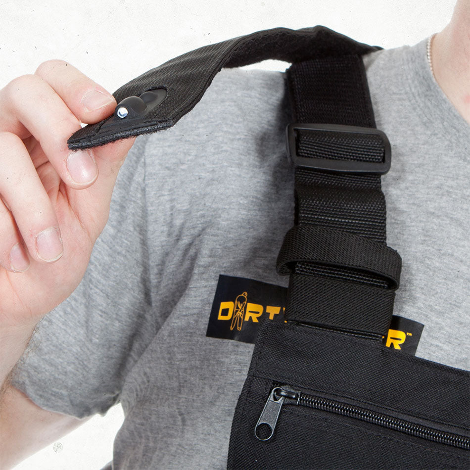 Hand angling the LED on the chest rig's shoulder strap, above the strap buckle and zip pocket