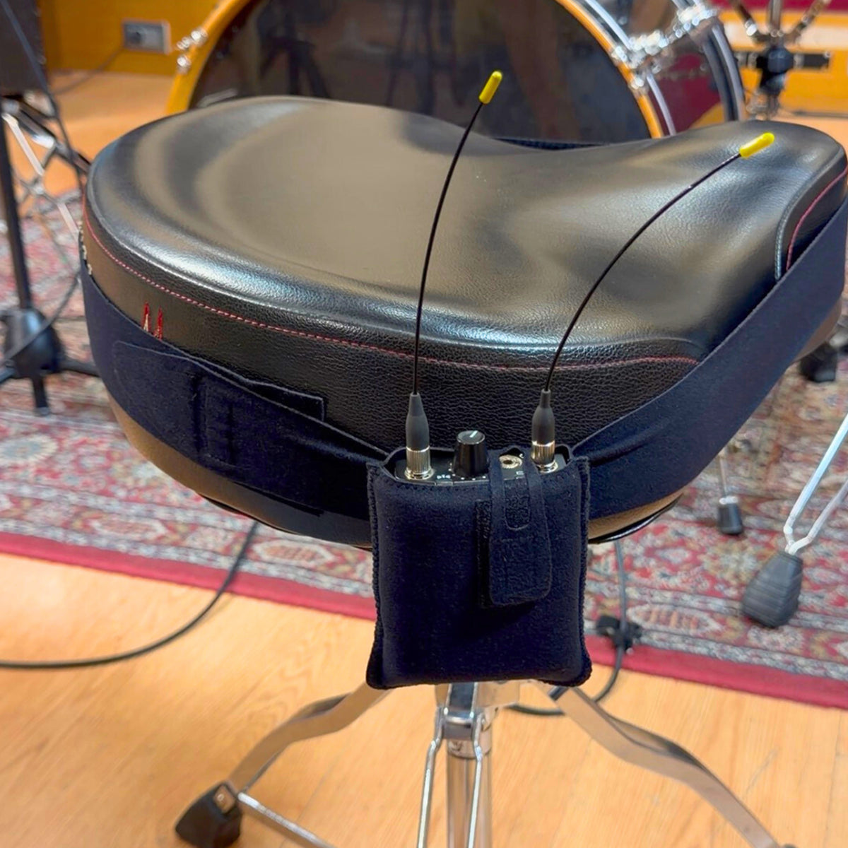 Viviana drum IEM pouch holding a receiver on a strap wrapped around a drum stool