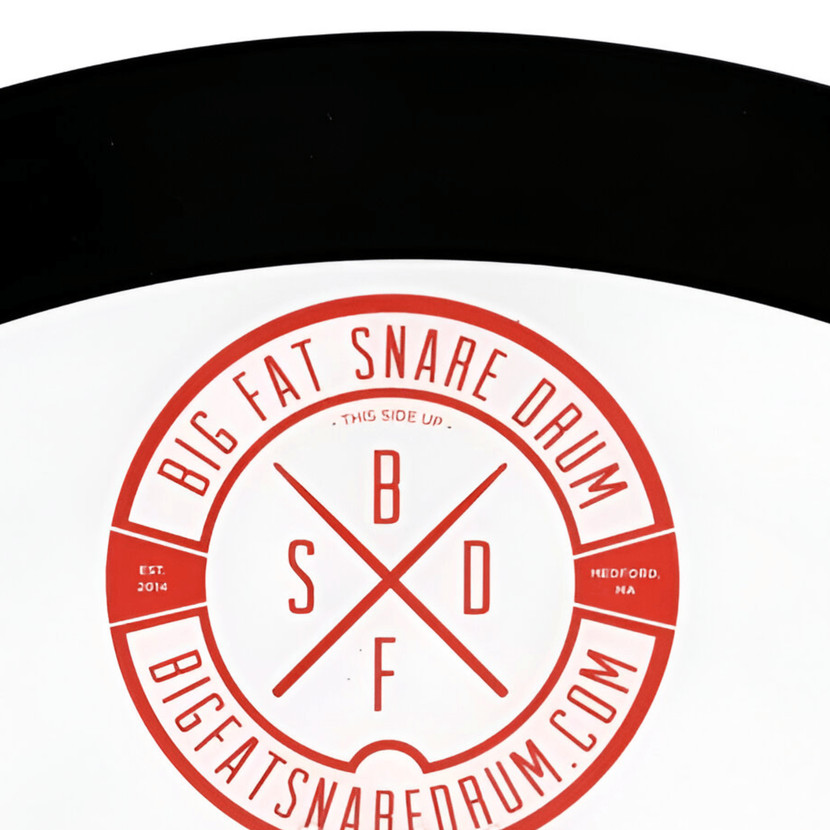 Close-up of the red Big Fat Snare Drum logo marked 'This side up', Est. 2014, Medford MA