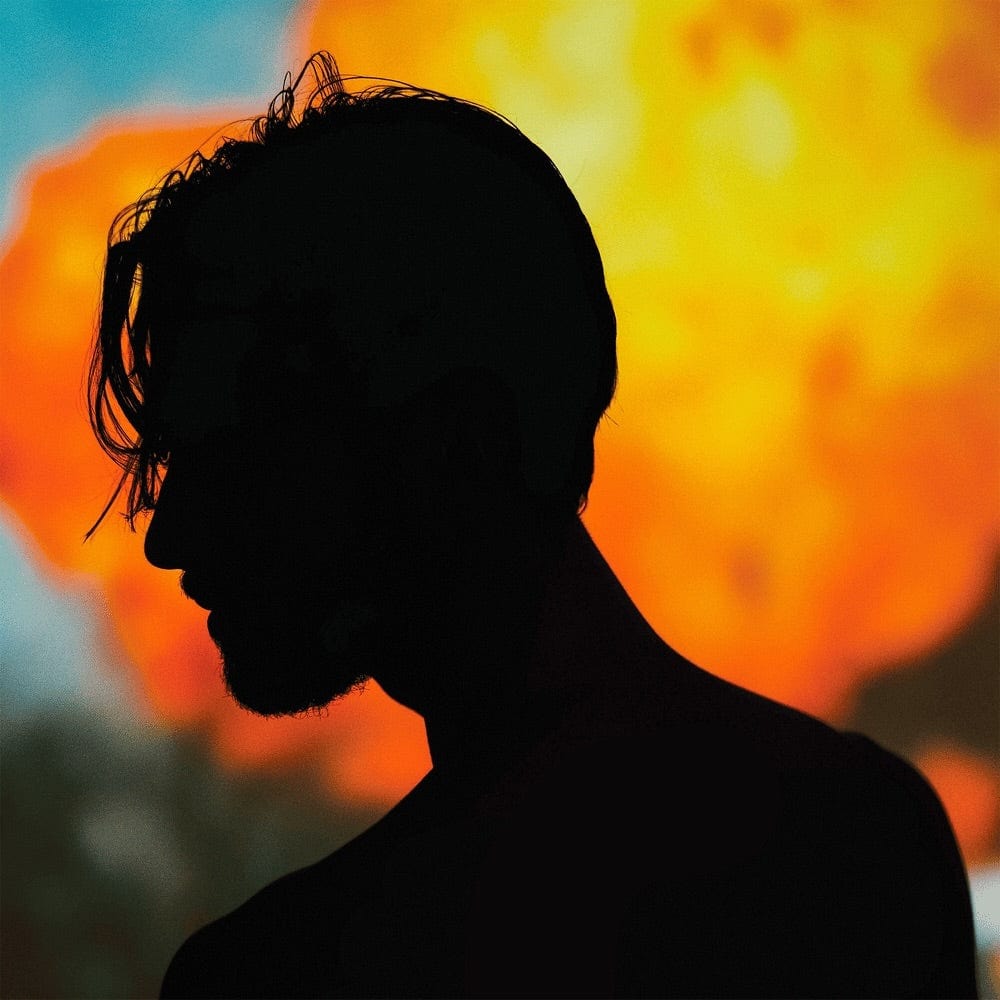 Silhouette of a man's profile against an orange fireball and blue sky