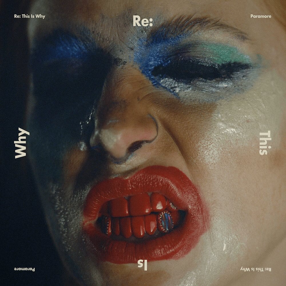 Square artwork with a close-up of a face in smudged blue eyeshadow, red lipstick and red grills