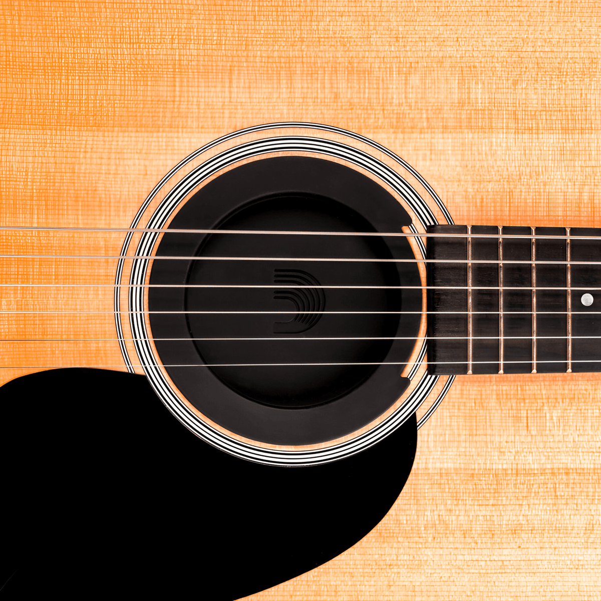 Screeching Halt fitted in an acoustic guitar soundhole beneath the strings