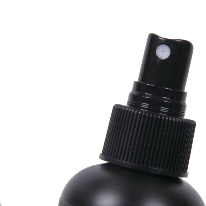Close-up of the black pump spray nozzle and ribbed cap on the Dunlop Formula No. 65 bottle