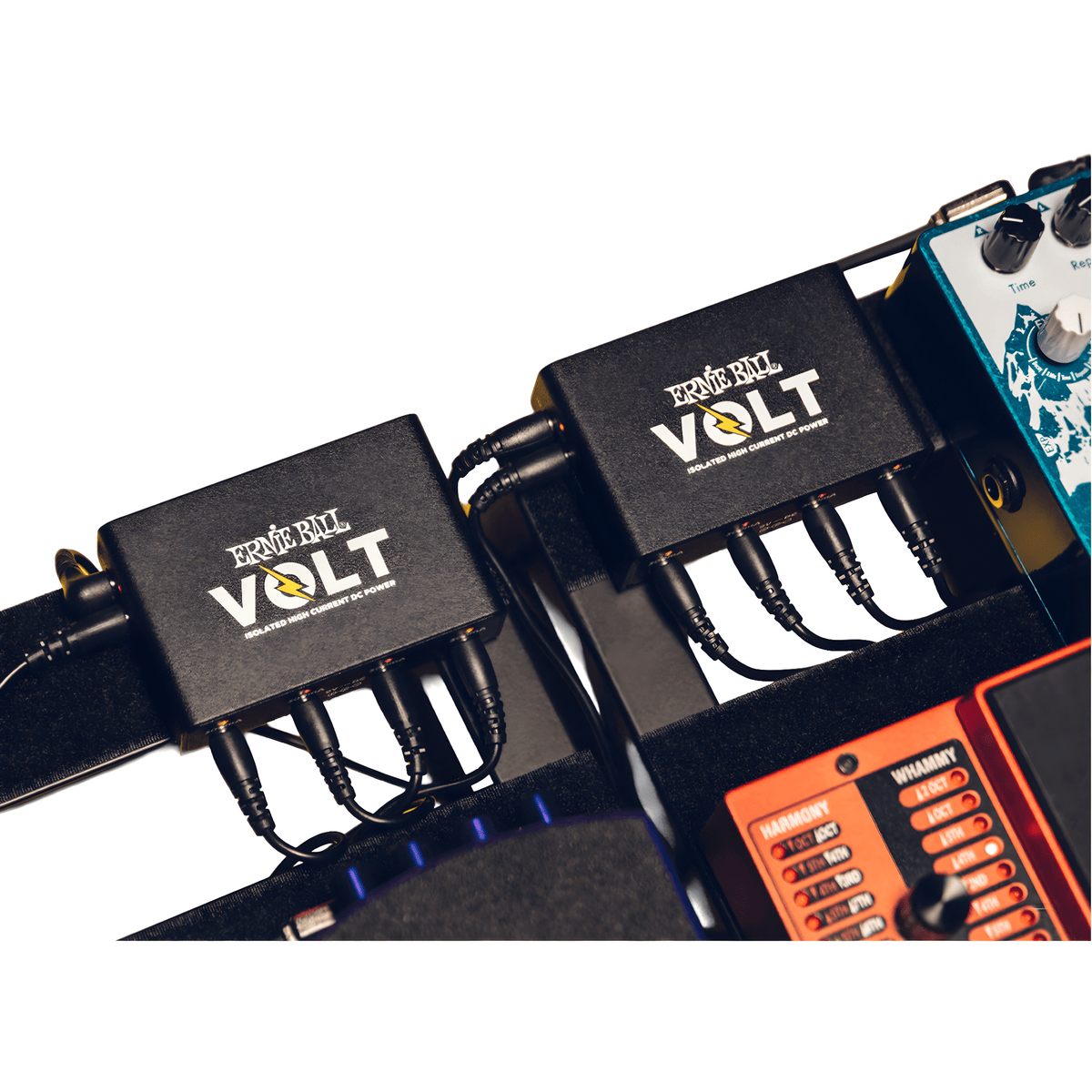 Two Ernie Ball Volt units daisy-chained on a pedalboard, DC cables running to the pedals