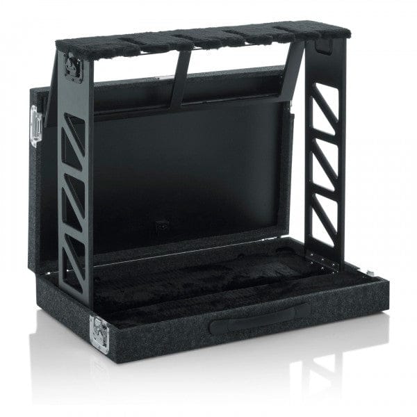 Gator GTRSTD4 unfolded into a four-guitar rack stand, empty, black frame rising from the carpeted case base