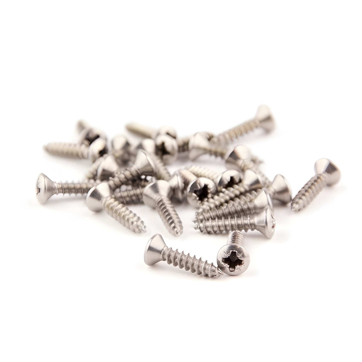 Loose pile of nickel-finish Guitar Man pickguard screws on a white background