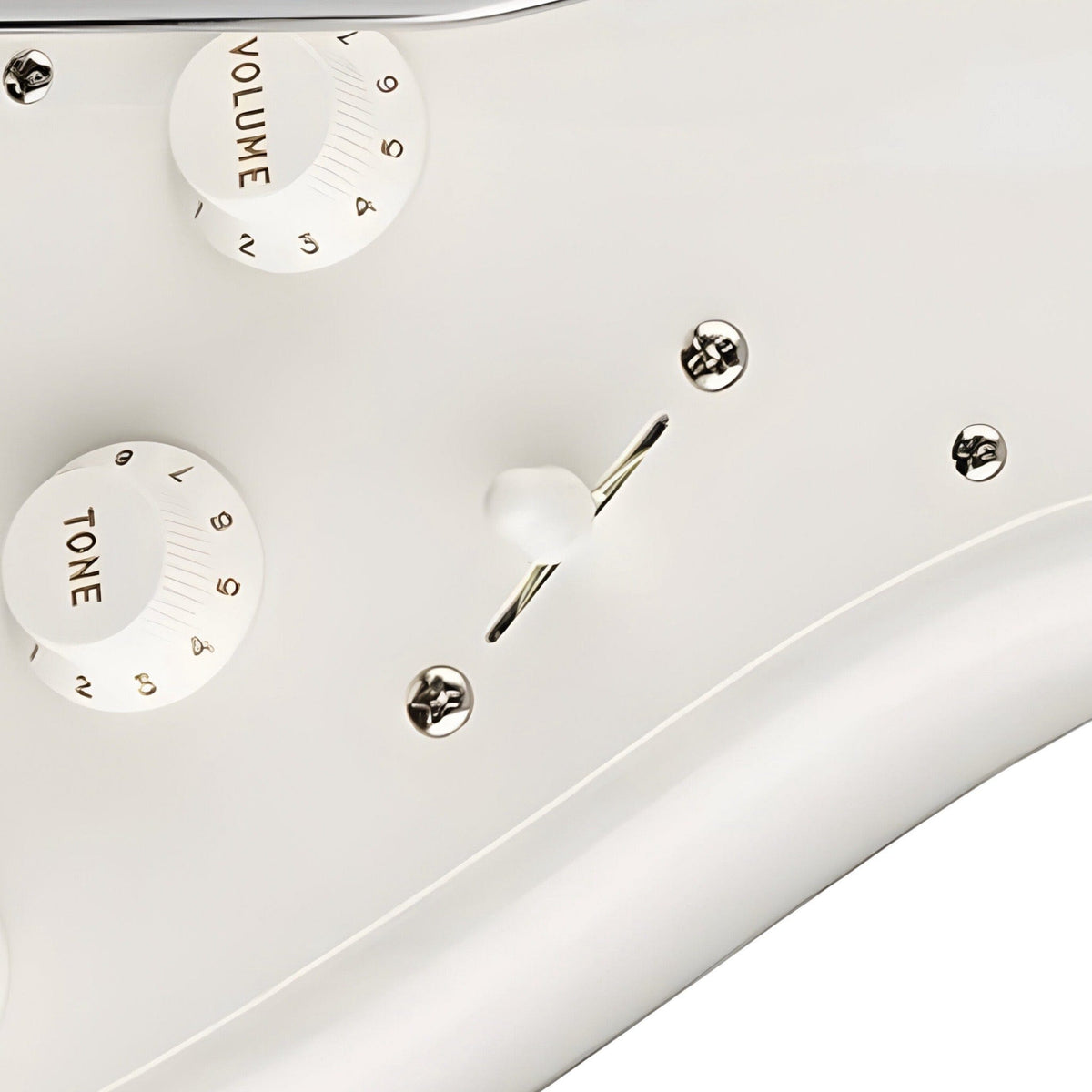 White switch tip on the pickup selector of a Strat-style guitar with white pickguard and white knobs