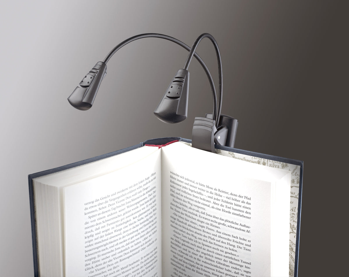 K&M Double LED FlexLight clipped to the cover of an open hardback book