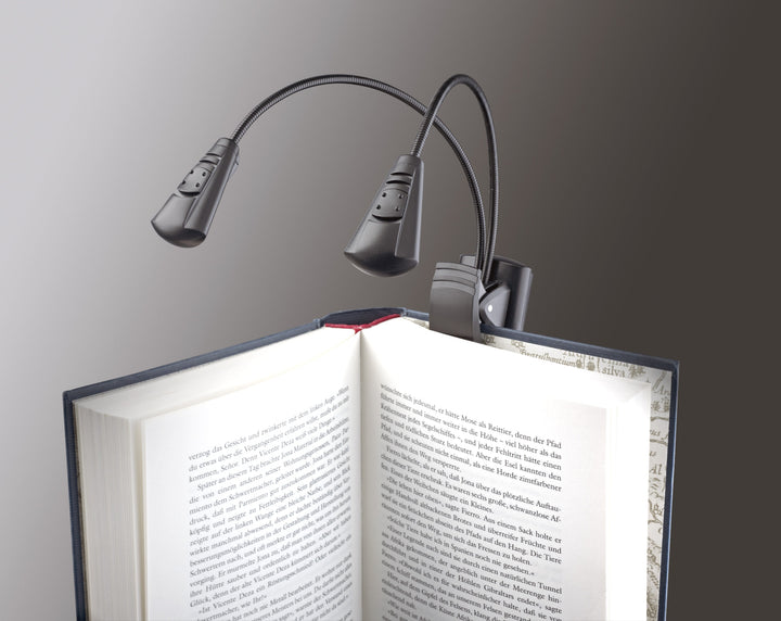 K&M Double LED FlexLight clipped to the cover of an open hardback book