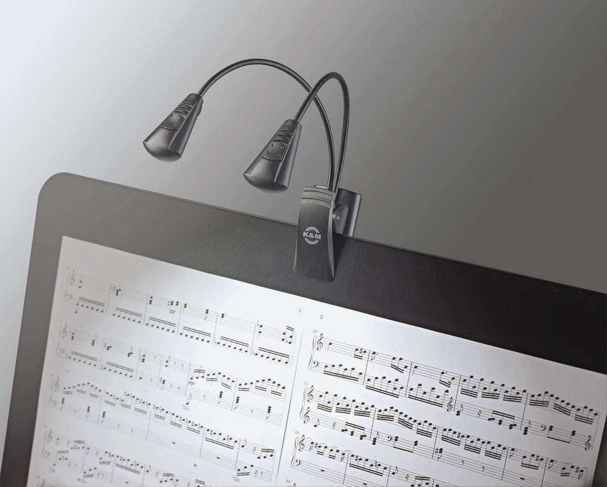K&M Double LED FlexLight clipped to a music stand, both heads lighting sheet music