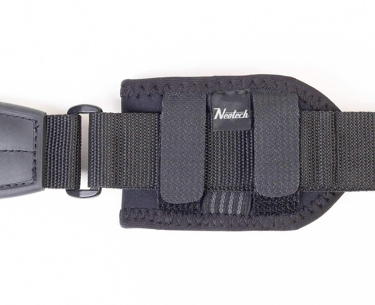 Back of the Neotech Wireless Pouch fixed to a black guitar strap with its two hook-and-loop straps