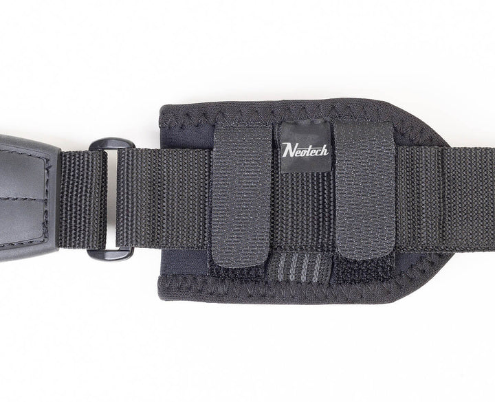 Back of the Neotech Wireless Pouch fixed to a black guitar strap with its two hook-and-loop straps