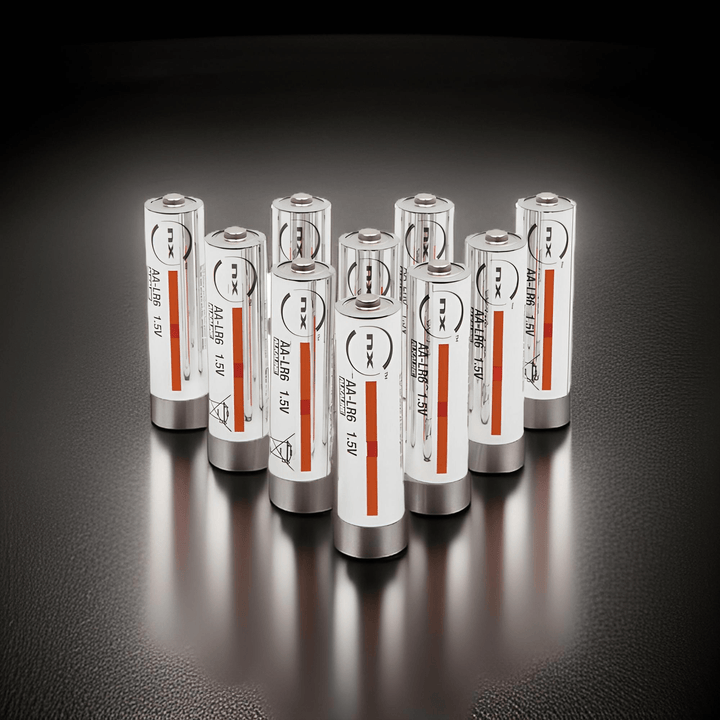 Ten NX AA LR6 1.5V alkaline batteries standing in rows on a dark reflective surface