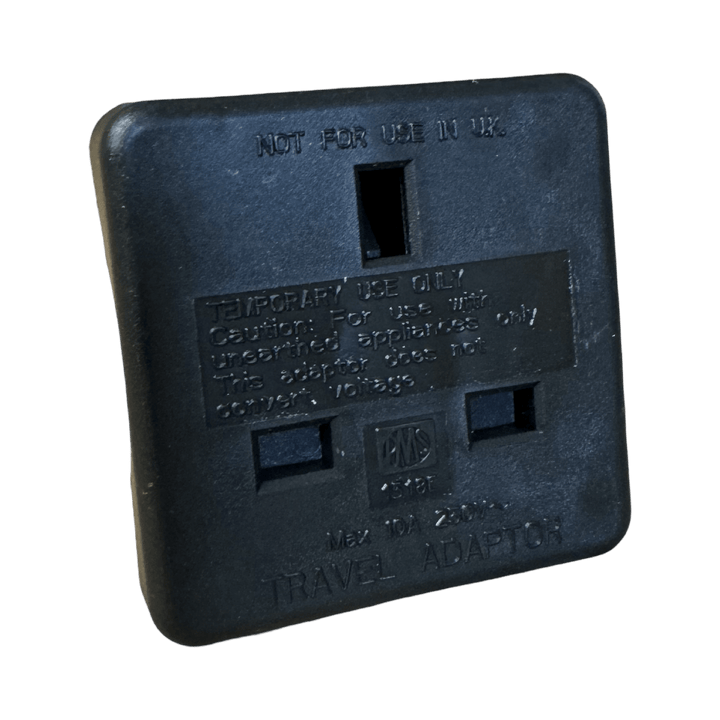 UK 3-pin socket face of the black Pro-Elec UK to US adaptor, marked Not for use in UK and Temporary use only