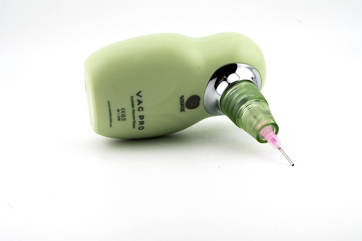 Soundz Vac-Pro lying on its side with needle nozzle attached, Vac Pro label visible