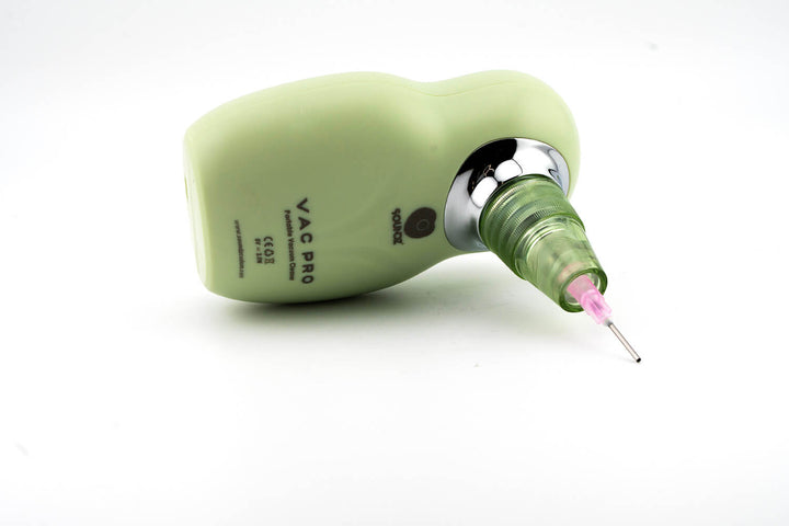 Soundz Vac-Pro lying on its side with needle nozzle attached, Vac Pro label visible