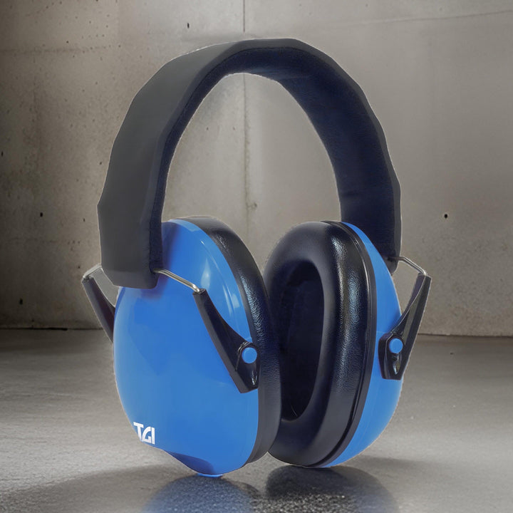 Blue TGI Junior Ear Defenders standing upright on a concrete floor