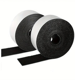 Two rolls of black hook and loop strip with white backing, ends unrolled to show the hook and loop faces