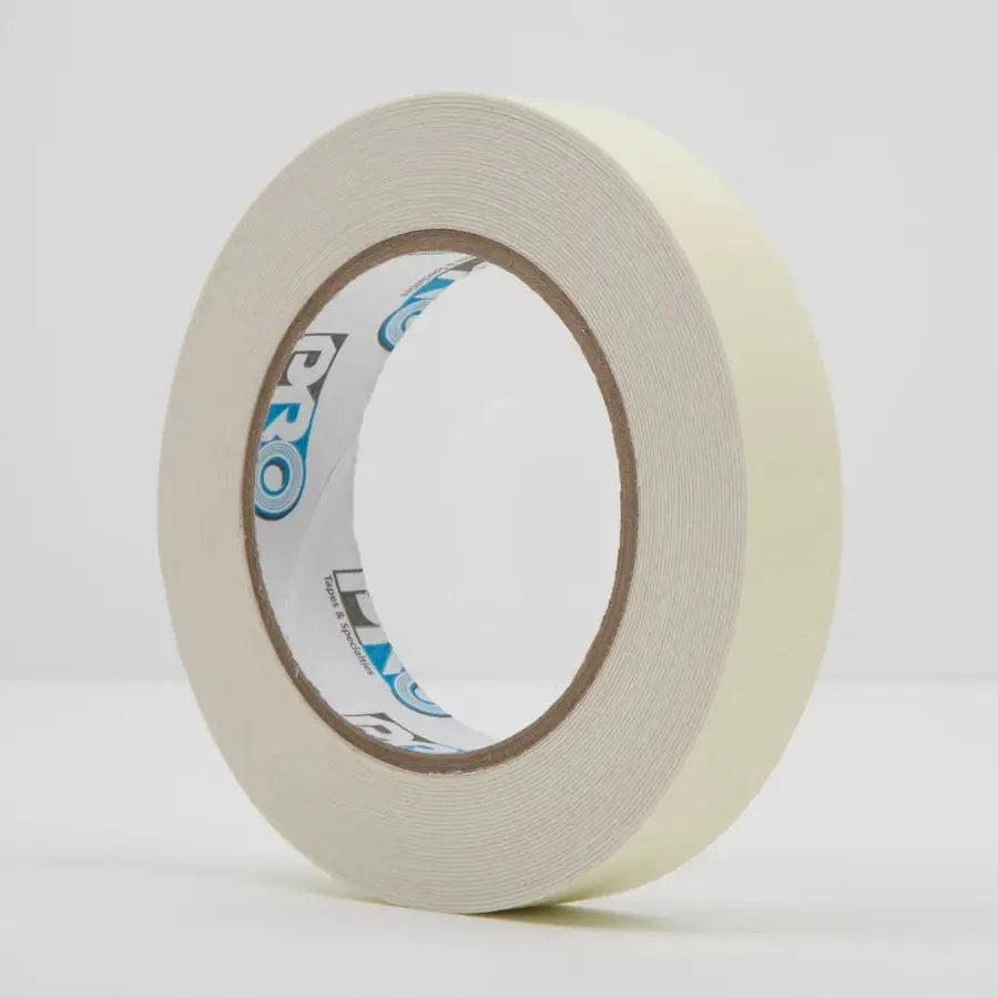 Pro Glow photoluminescent tape roll in daylight: pale cream-yellow tape on a core printed with the blue Pro logo