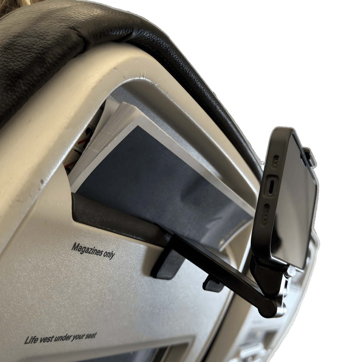 Side view of the phone holder hooked over a seat-back, holding a phone angled towards the passenger