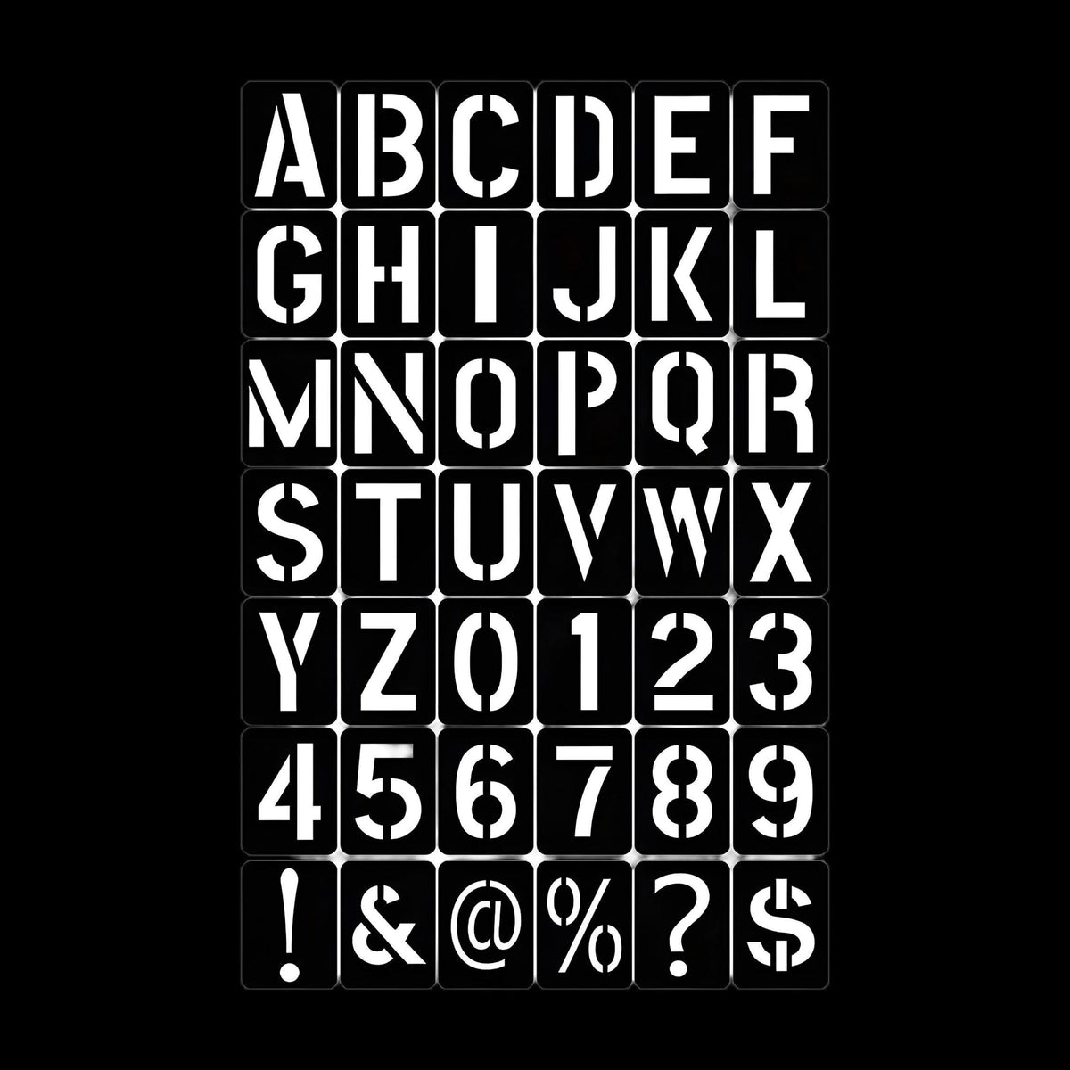 Roadcase stencil kit laid out on a black background showing every letter, number and symbol