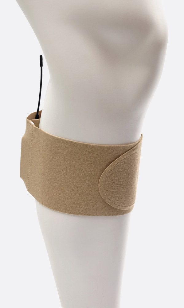 Beige URSA calf strap fastened around a mannequin's lower leg, transmitter antenna showing from the pouch