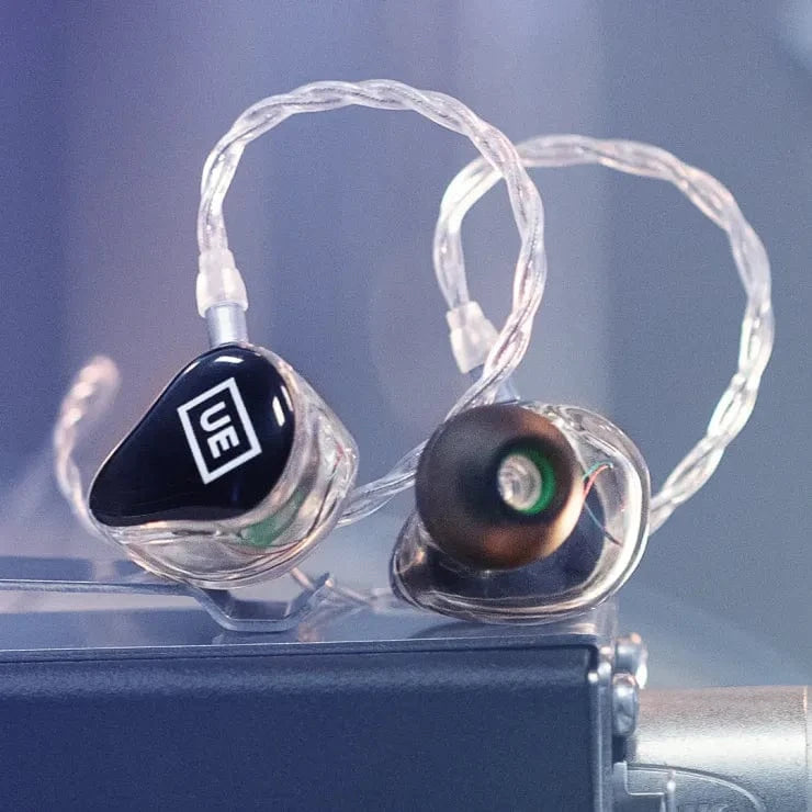 Pair of Ultimate Ears universal IEMs with clear shells, black UE faceplates and over-ear clear cable
